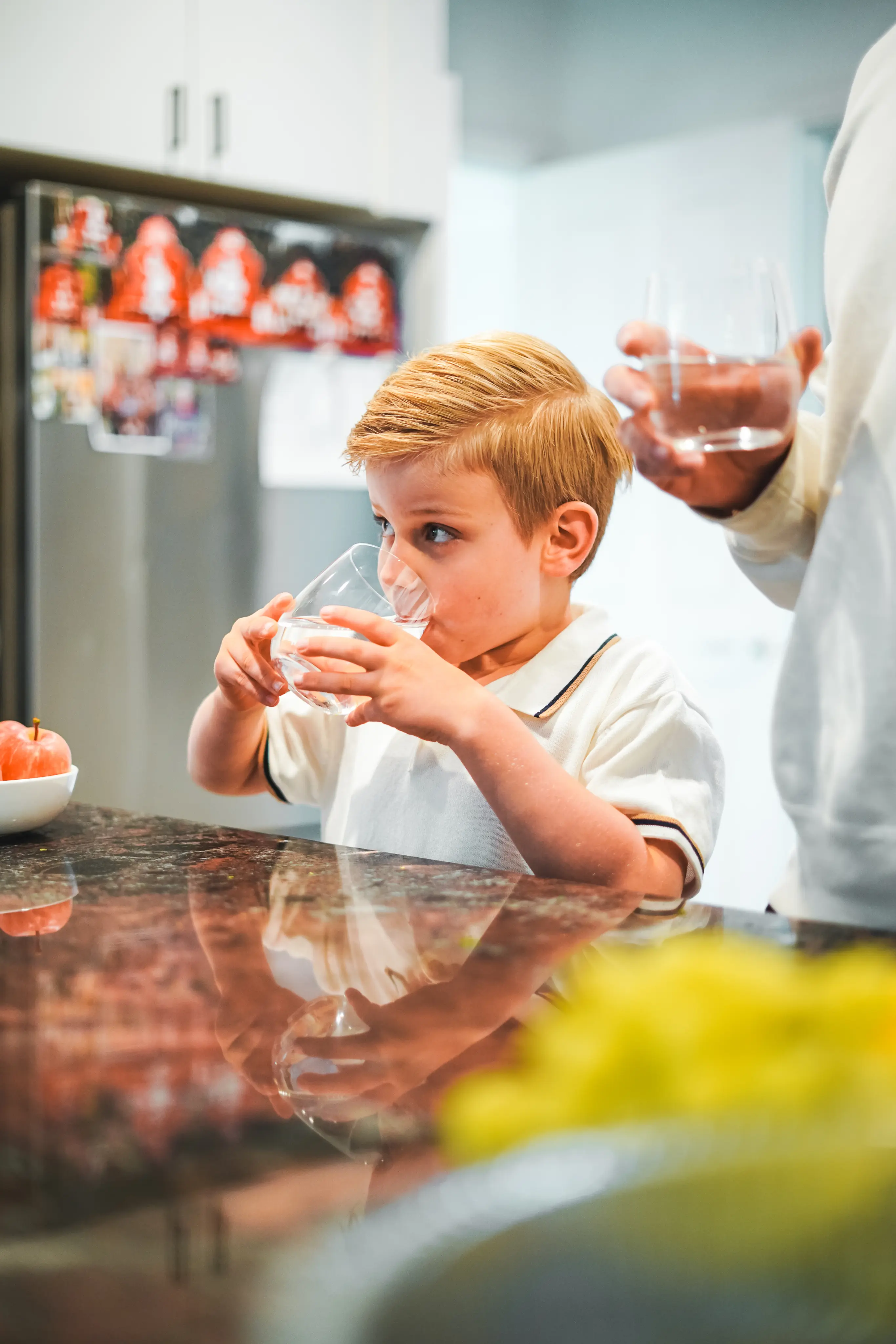 Family enjoying filtered water in a kitchen