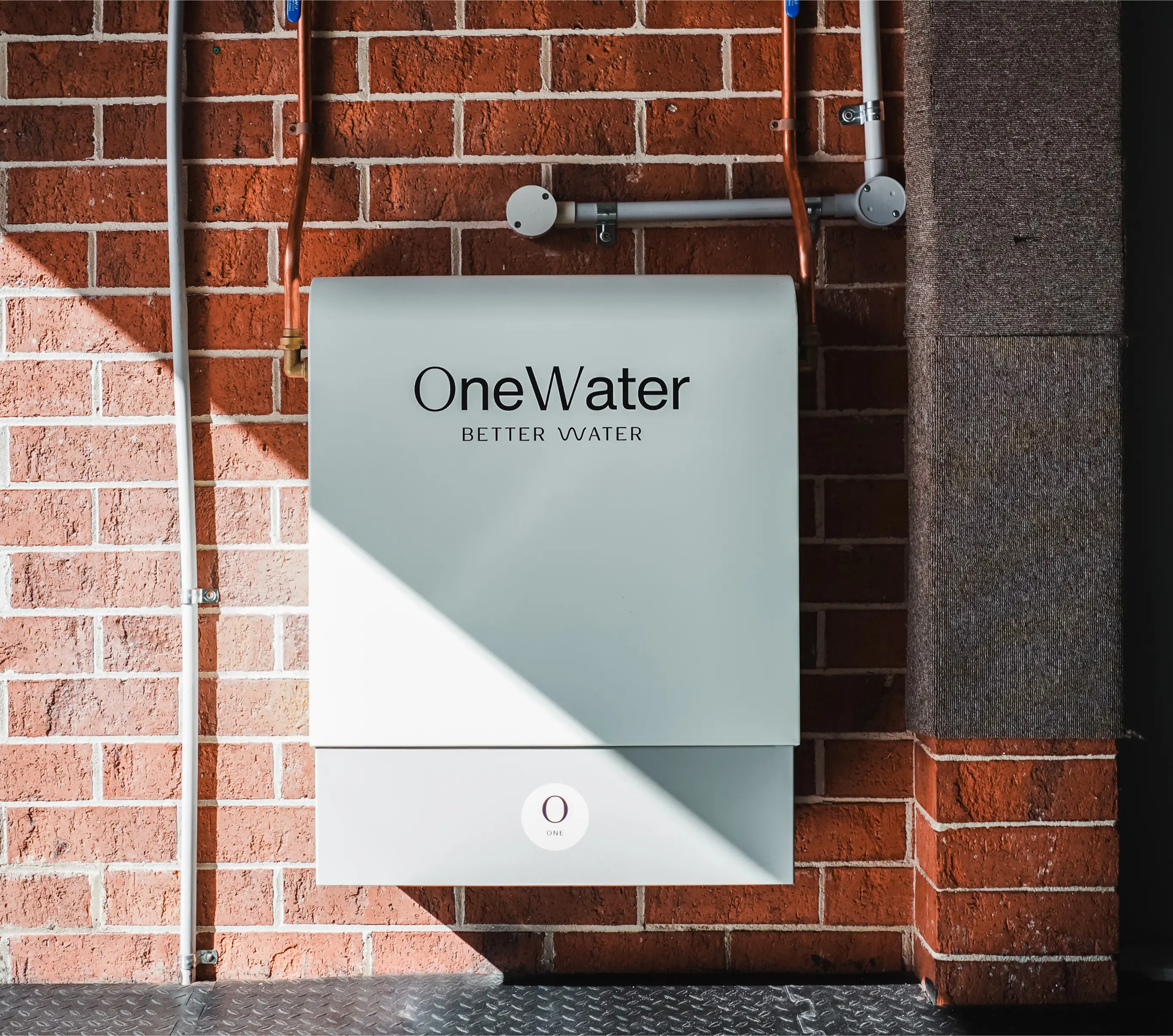 Australian family at kitchen sink enjoying purified water from OneWater system